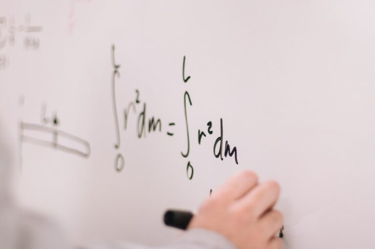CAE 12 person writing on white paper